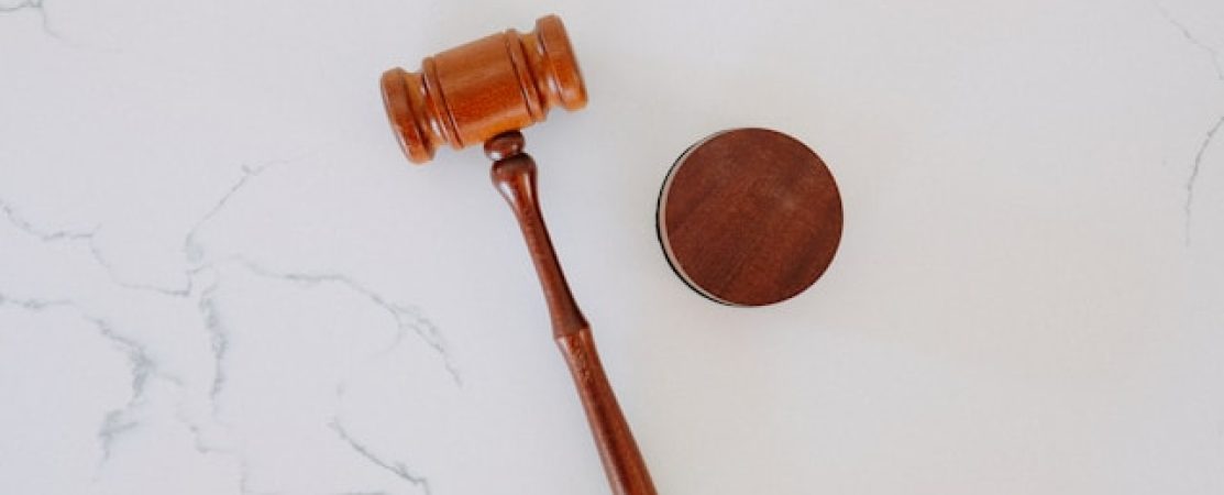 Photo of a judges gavel and block next to each other.